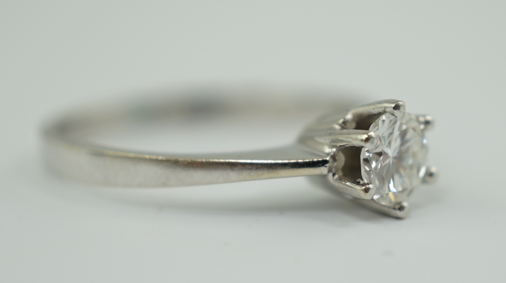 A modern 14k gold and solitaire diamond set ring